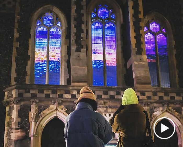 captivating projection of starling murmurations fills windows of converted church in brighton