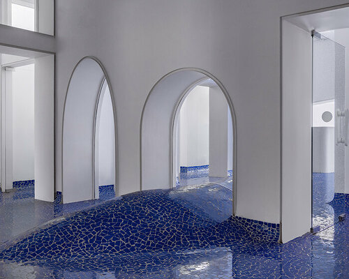 abin design studio sculpts its art rickshaw gallery with 'islands' of undulating blue tilework