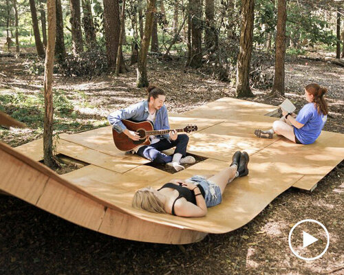 sweeping arches + decks of wood-laminate form i/thee’s stage at site of woodstock festival