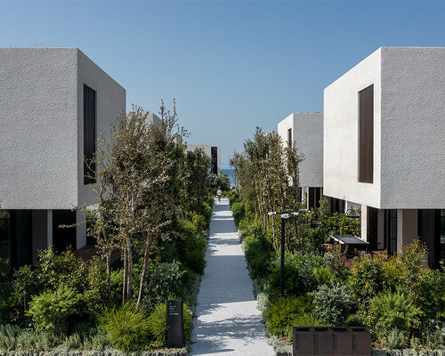 CAJA resort highlights scenic beach in turkey with arrangement of white-washed cubic villas