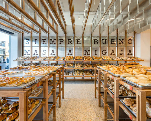 concèntrico surrounds mi pan bakery in mexico with hanging metallic trays and pinewood