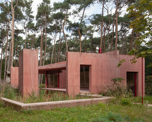 NWLND architects composes an enclosed garden 'refuge' of red concrete in belgium