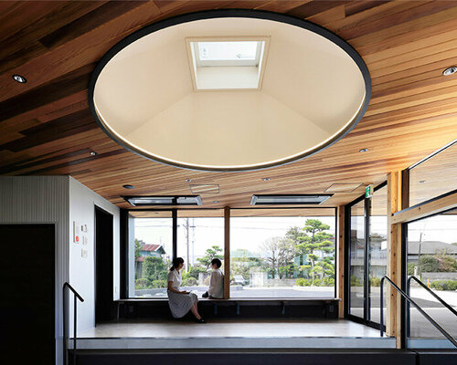 symbolic circular skylight fills sugawaradaisuke's family clinic in japan with natural light