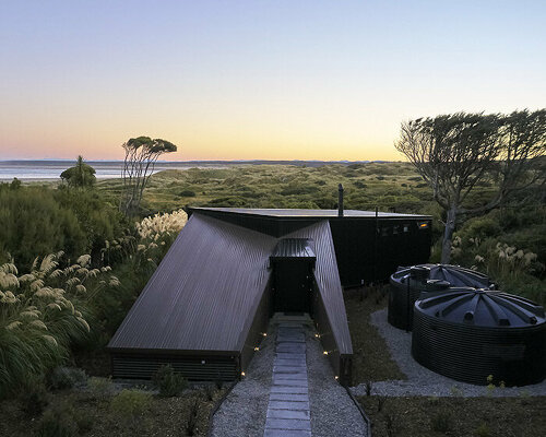 stacey farrell-designed 'coast house' hunkers down among new zealand dunes