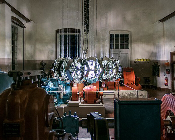 thomas medicus suspends turbine-shaped glass installation at hydropower plant in austria