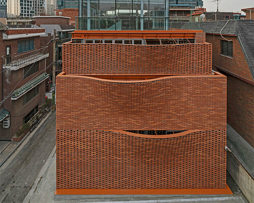 undulating red brick facade envelops 'wave' commercial building by JYA-rchitects in seoul