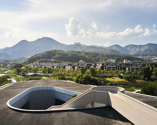 winding staircase of g-lake art gallery culminates with scenic views of chinese mountainscape