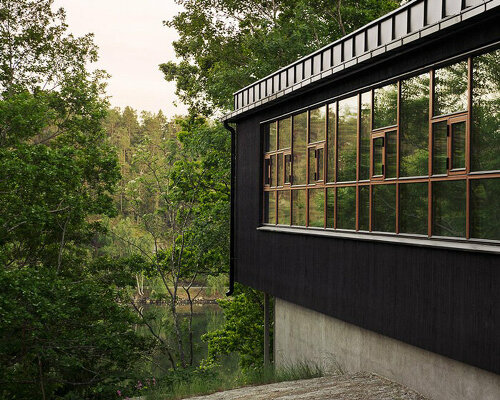 andrénfogelström nestles wooden villa with copper-clad bridge in swedish archipelago