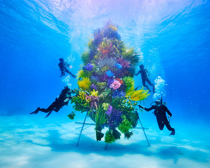 azuma makoto submerges intricate botanical sculpture in the clear waters of japan