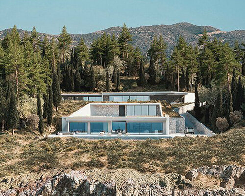 studio façade wedges a white-prismed villa into the greek cliffs of lefkada