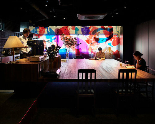 a movable, pleated artwork floods this japanese cafe with a homely ambiance