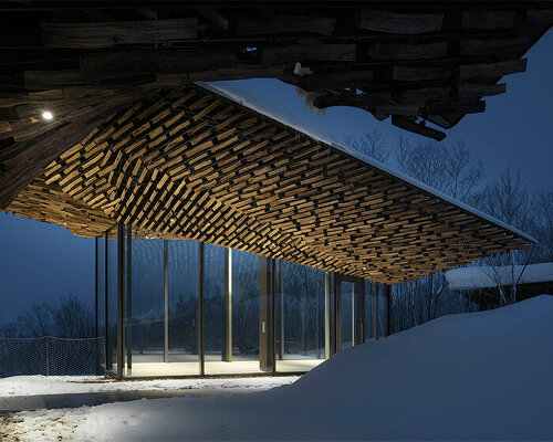 kengo kuma's firewood roof for 'snow peak' spa resort echoes mountain ridgeline in japan