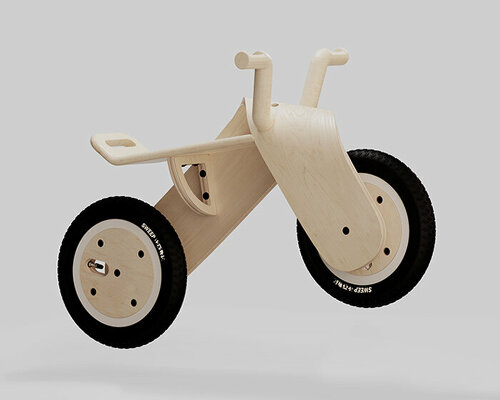 bored eye design sculpts children's balance bike using a sweeping, wooden form