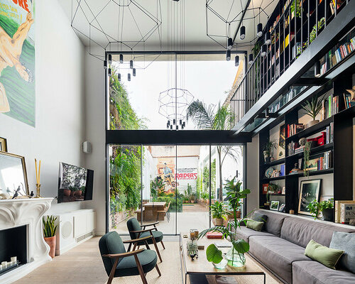 'the library' is a renovated triplex in barcelona with open, breathable spaces