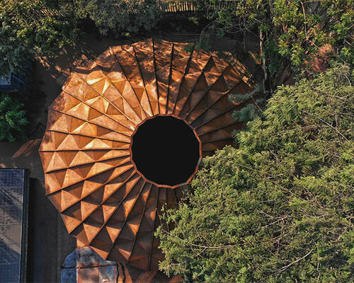 parametric metal tent with ridge paneled facade serves as multipurpose events space in india