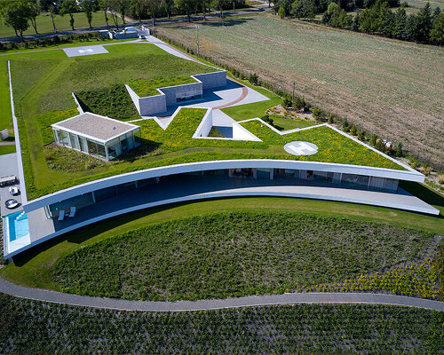 mobius architekci carves dune-shaped residence into lush hillside site in poland