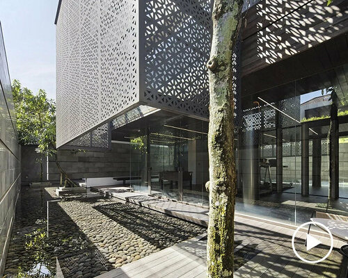 perforated laser-cut panels filter sunlight for 'golfn' residence in indonesia