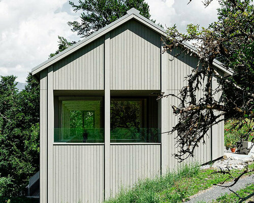 grey wooden framework shapes stable-like residence in swiss village