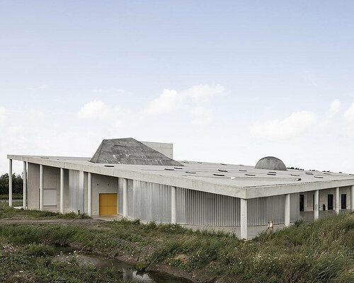 inclined roof dotted with abstract shapes tops office KGDVS' crematorium in belgium