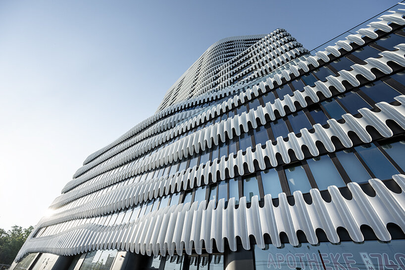 j. mayer h. wraps its newly completed tower with a 'zipper' facade