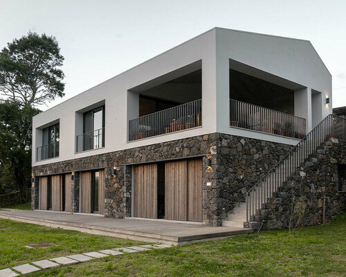 mezzo atelier completes concrete + local basalt stone dwelling in são miguel island