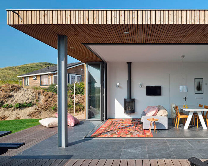 'tiny house vlieland' unfolds to blend with dutch island's dune landscape