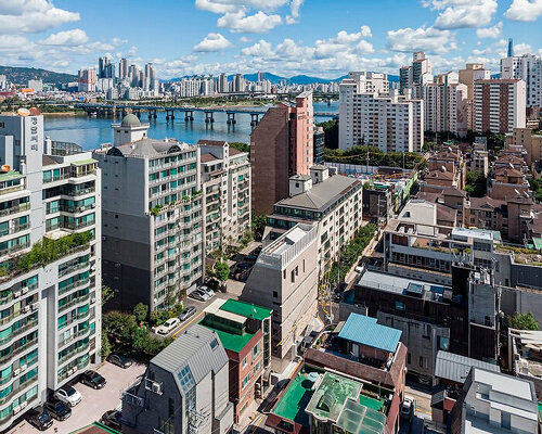 stacked brick multi-level building renders floating illusion in seoul's most popular avenue