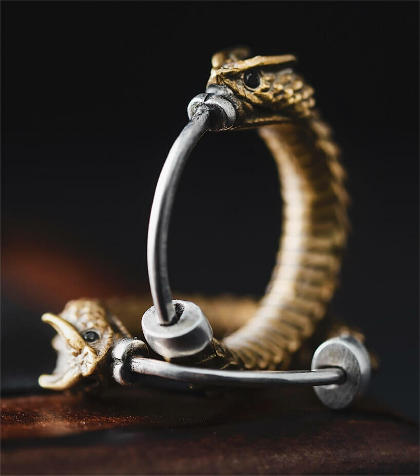 https://www.designboom.com/wp-content/uploads/2022/11/brass-rattlesnake-earrings-coppertist-wu-ancient-symbol-hope-eternity-designboom-2.jpg