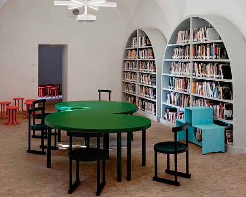 bold colors + geometric shapes revive art library in ganda castle's medieval structure