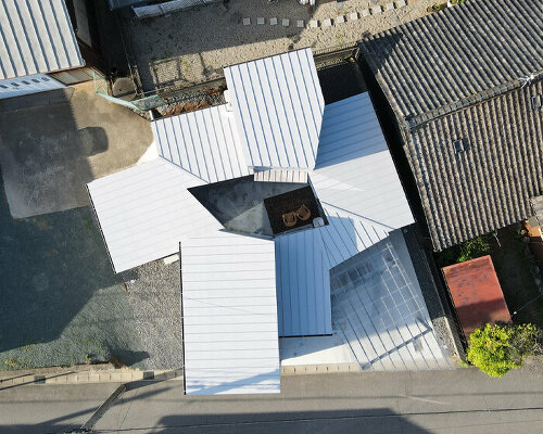 a cluster of irregular volumes envelops this private courtyard in aichi, japan