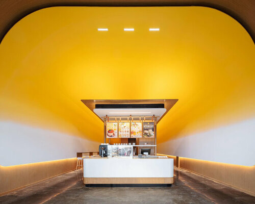 cave café in canada shines like the sun with yolk yellow interior