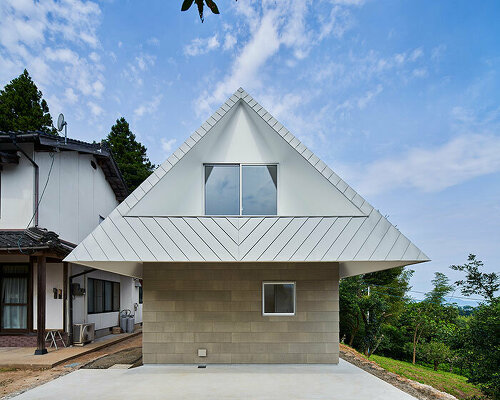 cut-out triangular roof frames extensive panoramas of rural japan