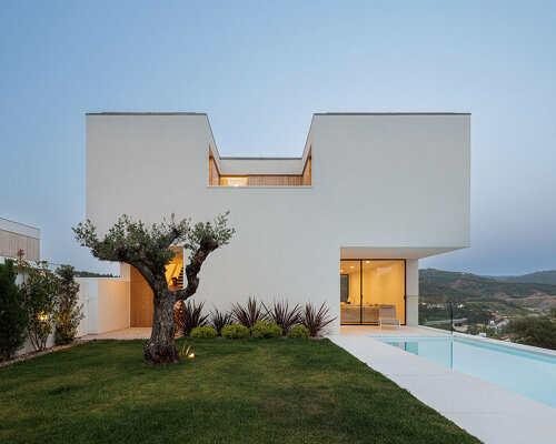 a minimalist house by mário alves emerges from the hills over portugal