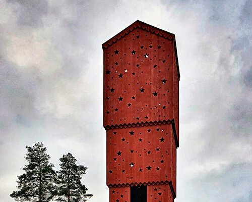 schoolyard stacked house sculpture by UMA lights up through cut-out stars