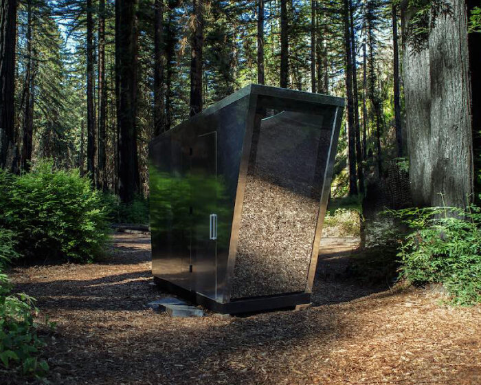 'the portal' toilet camouflages in the woods like a sci-fi doorway