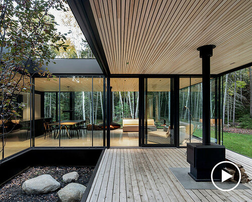 in the forests of quebec, a glass house surrounds an apple tree courtyard