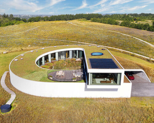 BIG completes slithering villa gug on the countryside hills of northern denmark