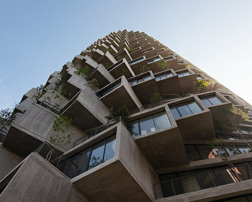 bjarke ingels' IQON tower rises over quito with a pixelated facade of raw concrete