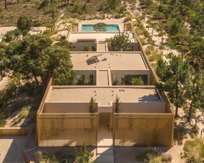 in portugal, 'casa em tróia' by BICA arquitectos seamlessly mirrors its coastal surroundings