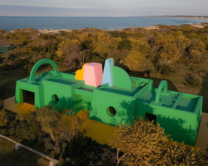 vibrant art center 'casa neptuna' stands out amid native forest landscape in uruguay