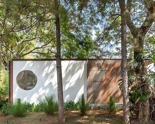 perforated louvers in corten steel envelop getaway cabin in belo horizonte, brazil