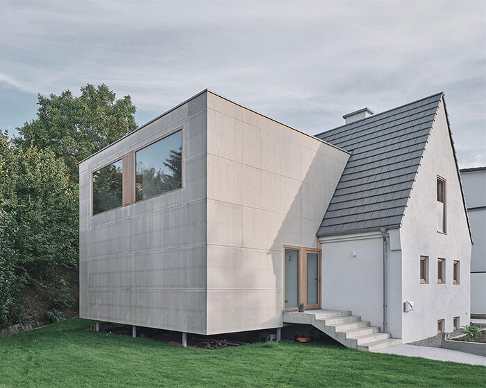 past & present overlap within henning grahn's wooden residential extension in germany