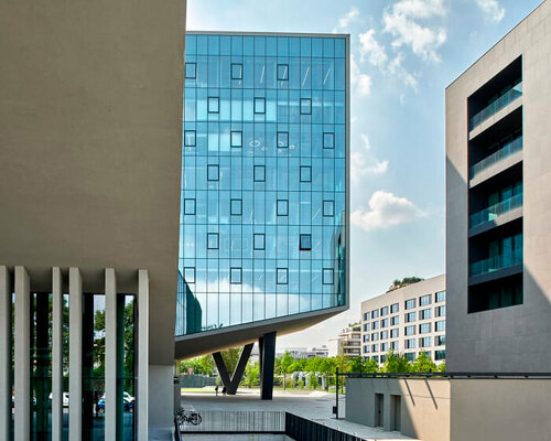 glass office building by ACPV towers over symbiosis business district in milan