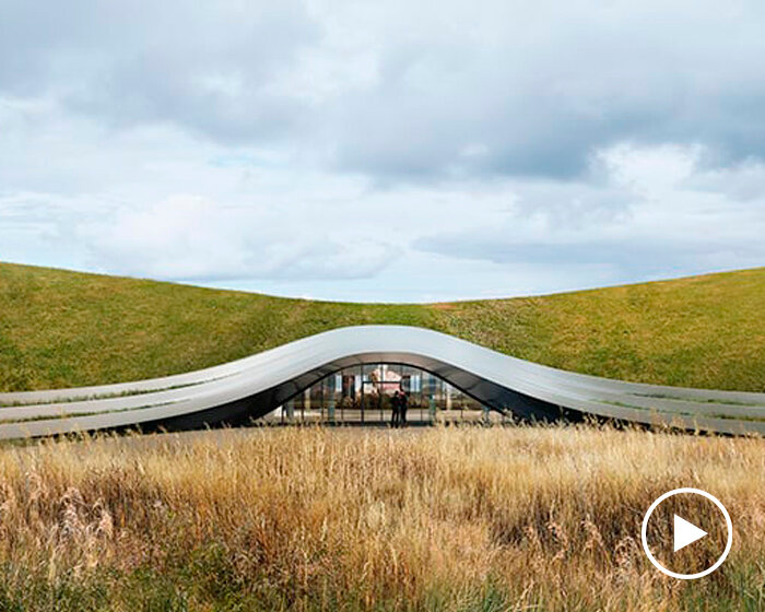 unism studio blends subterranean factory's green roof into the polish rural landscape