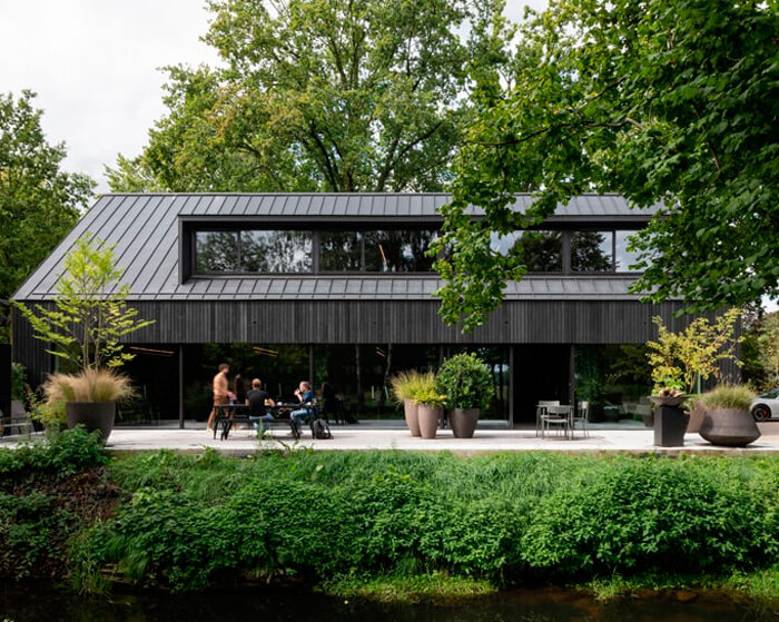 studio] [space nestles black barn-shaped office into the dutch landscape