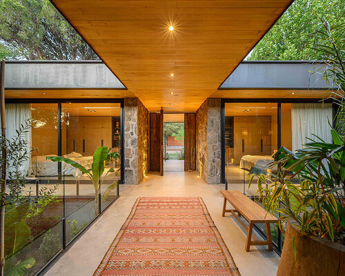 a house of stone dubbed 'casa piedra' shows warm interiors in argentina