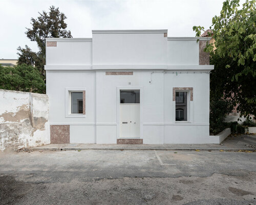 corpo atelier scatters pink limestone across a portuguese villa's traditional, all-white exterior