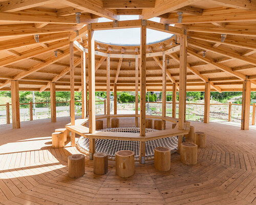 cloud architects weaves circular kiosk into the lush mountainous landscape of japan