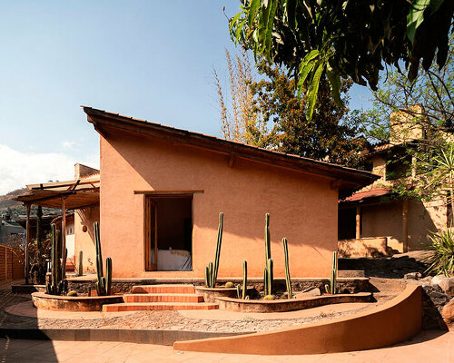 abobe skin made of clay and straw shapes vacation house 'casa corsal' in mexico