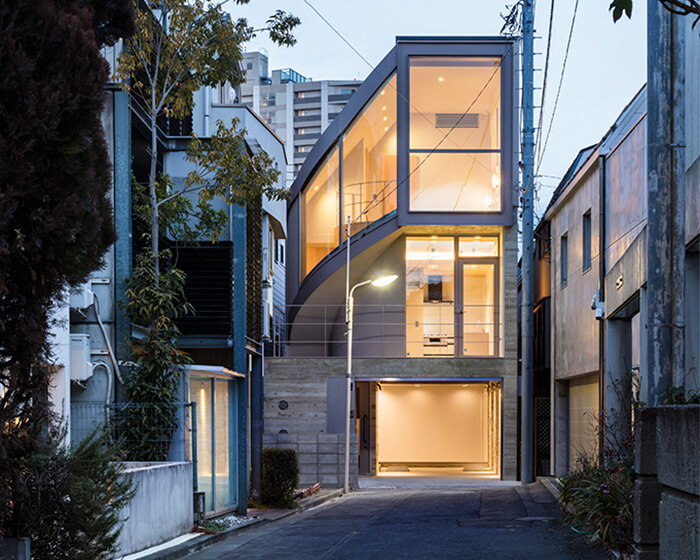 curved glass-enclosed staircase peeps out of tokyo house that 'dances in the city'